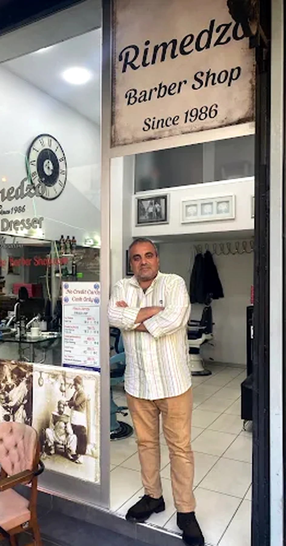 Ibrahim standing at the entrance of Rimedzo Barber Shop in Sultanahmet